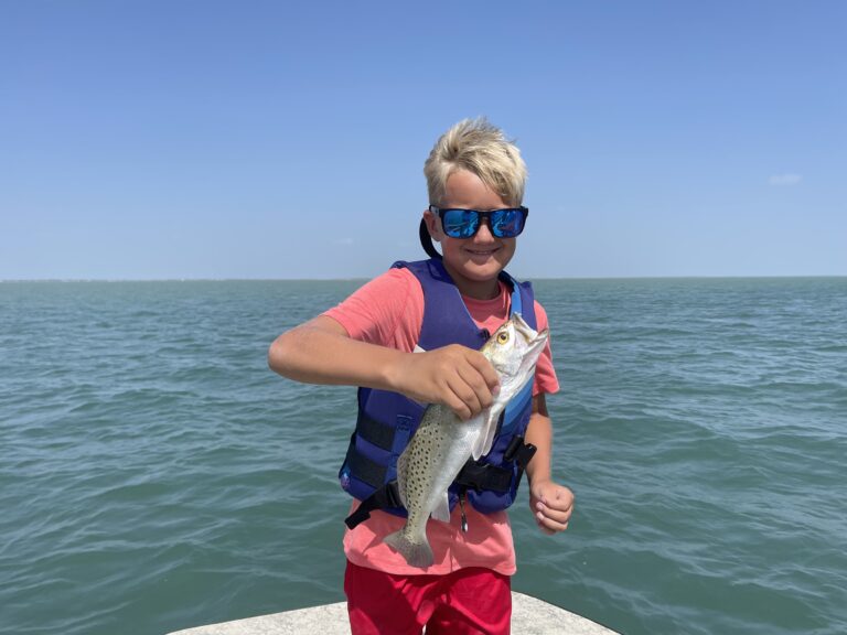 South Padre Island bay fishing — young angler holding a catch